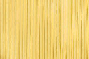 Closeup abstract pattern at yellow women's clothing textured background