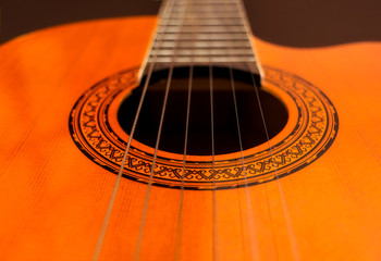 Obraz premium Rosette and strings of an acoustic guitar close up. Classical Spanish guitar. Musical instrument.