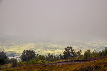 View of village covered in fog at Carpathian mountains