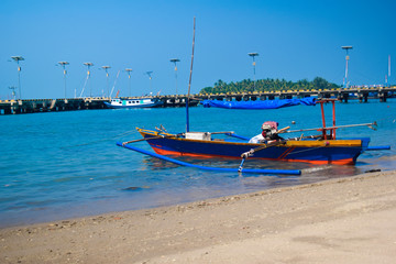 Fototapeta premium Traditional sailing wooden boat on the water parking at the harbour in summer holiday in Lampung, Indonesia