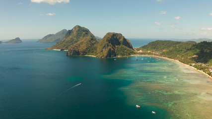 Aerial view bay with lagoon and turquoise water on a tropical island against the backdrop of the mountains. Corong corong beach, El Nido, Palawan, Philippines. Summer and travel vacation concept
