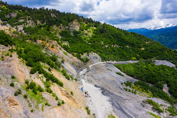 Amazing view of the landslide on a mountain road. The road from Mestia to Zugdidi was blocked by an rockfall. Road services are clearing the mountain road serpentine.