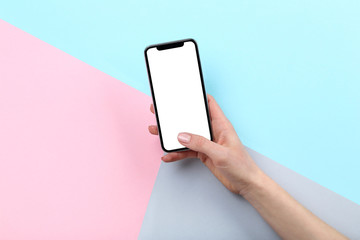 Smartphone in female hand on colorful background