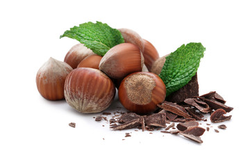 Hazelnuts with chocolate and mint leafs isolated on white background