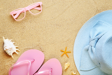 Fototapeta na wymiar Beach clothing with seashells and glasses on sand