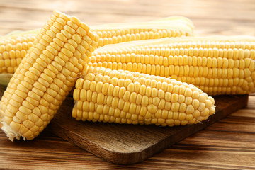 Ripe corn on brown wooden table