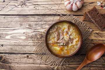 Kharcho soup with meat and rice on wooden table