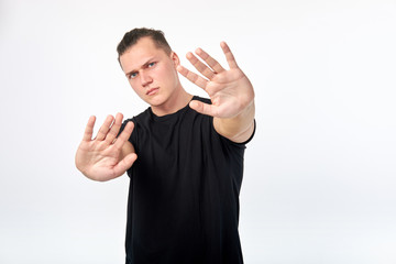 Gesture of denial. Body language. Young unhappy scared man showing a gesture of denial or stop....
