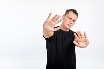 Gesture of denial. Body language. Young unhappy scared man showing a gesture of denial or stop....