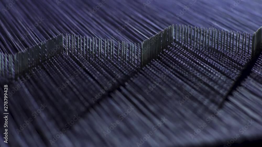 Poster Close up of denim threads being carefully sorted by a machine at high-speed in a garment factory.