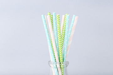 Colorful paper straws on grey background