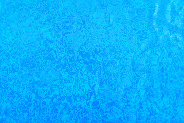 Fototapeta na wymiar Background of a pool tiles, white and blue, through the water.