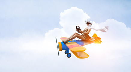 Woman in retro airplane . Mixed media