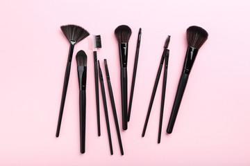 Makeup brushes on pink background