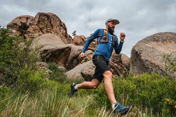 Male runner running on a mountain trail