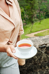 Woman with Drink Cup on Plantation Background
