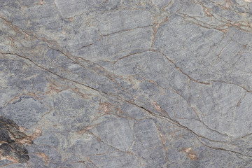 Gray stone surface with stripes. Grunge abstract stone surface. This is a horizontal background.