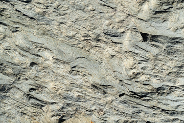 Modern light yellow wall with gray stripes. Background with a rough gray texture. Stone gray background. This is a horizontal background.