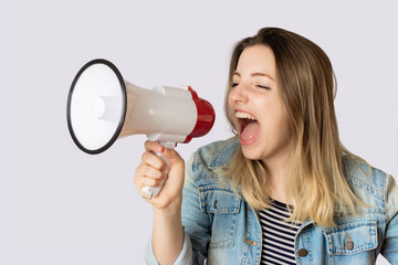 Young woman screaming on a megaphone.