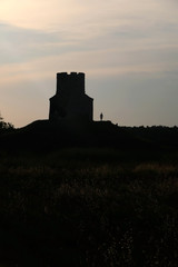 Obraz premium Silhouette of small medieval church of St. Nicholas and visitors around, near Nin, Croatia.