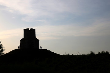 Obraz premium Silhouette of small medieval church of St. Nicholas and visitors around, near Nin, Croatia.