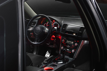 Fototapeta premium car inside gray seats red dashboard night photography in the dark