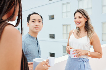 Group of business people communicating with each other during coffee break outdoors