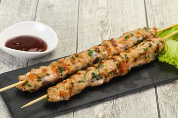 Minced pork skewer kebab with sauce