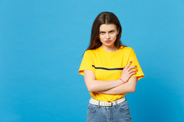 Portrait of displeased offended young woman in vivid casual clothes looking camera, holding hands...