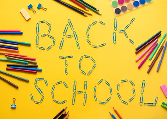 School elements on Yellow background with text back to school