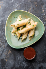 Paneer chilli cigar are crispy rolls stuffed with paneer which is an interesting starter for any party. served with tomato ketchup. selective focus