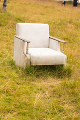 Fototapeta premium white chair on the grass sofa old relax seat comfortable furniture outdoor