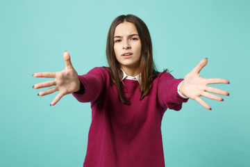 Young fun sad upset perplexed disturb brunette woman girl in red casual clothes posing isolated on blue wall background studio portrait. People sincere emotions lifestyle concept. Mock up copy space.