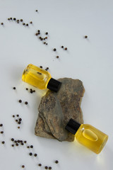 Bottles with black peper essential oil. Natural healthy cosmetic treatment products.