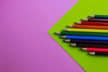 Assortment of pencils on color background