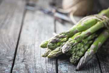 Bunch of fresh asparagus on wooden table