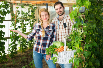Gardeners posing with vegetables harvest