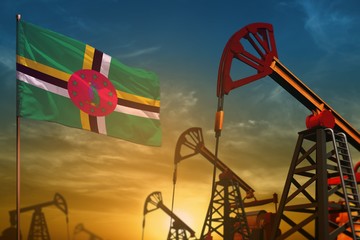 Dominica oil industry concept. Industrial illustration - Dominica flag and oil wells against the blue and yellow sunset sky background - 3D illustration