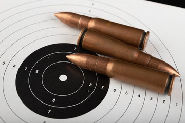 Ammunition rifle ammunition lying on the shield. Cartridges for a military rifle.