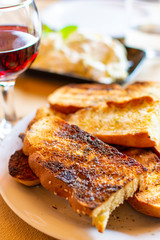 Greek food, roasted bread with olive oil and herbs, red wine and tzatziki sauce