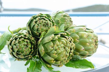 Fototapeta premium Bunch of fresh raw artichokes heads from artichoke plantation in Argolida, Greece ready to cook