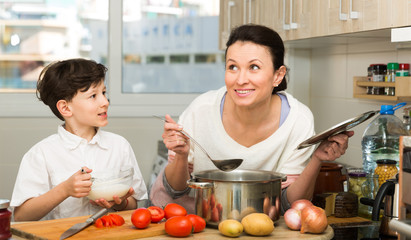 Happy mother and son cooking