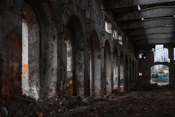 Fototapeta na wymiar Inside totally ruined red brick house. Ruins of industrial enterprise