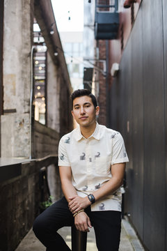 Portrait of young man sitting outdoors