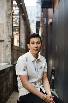 Portrait of young man sitting outdoors