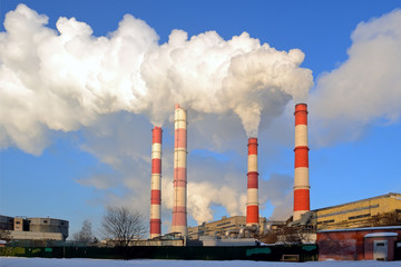 Thermal power plant, smoke from the chimney against blue sky