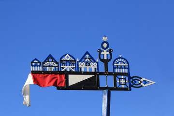 Nida, Lithuania - 04/21/2009: A traditional carved wooden weather vane, which local fishermen put on the mast of a boat.