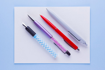 Back to school pop art concept. School stationery on pink blue background. Multicolored pens on pastel background. Flat lay. Copy space