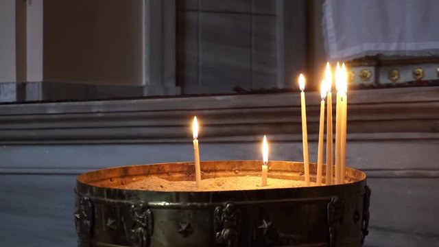 View at the Many ortodox Church Candles Burning in the Temple. Close up