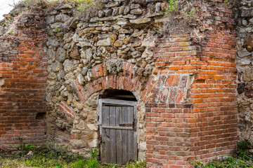 Fototapeta na wymiar An old cellar of bricks and stones on the territory of the estate Gorodnya (Galician nobles) near Kaluga. Ferzikovsky District, Kaluzhskiy region, Russia - July 2019